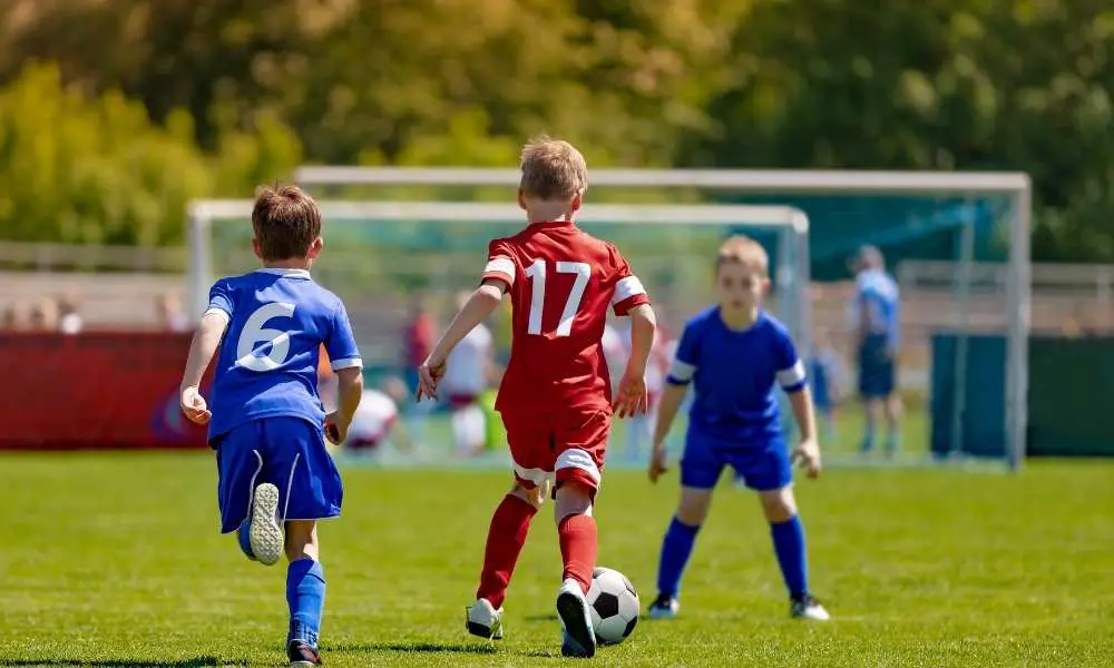 Young soccer player dribbling soccer ball